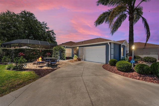 ranch-style home featuring an attached garage, stucco siding, and concrete driveway
