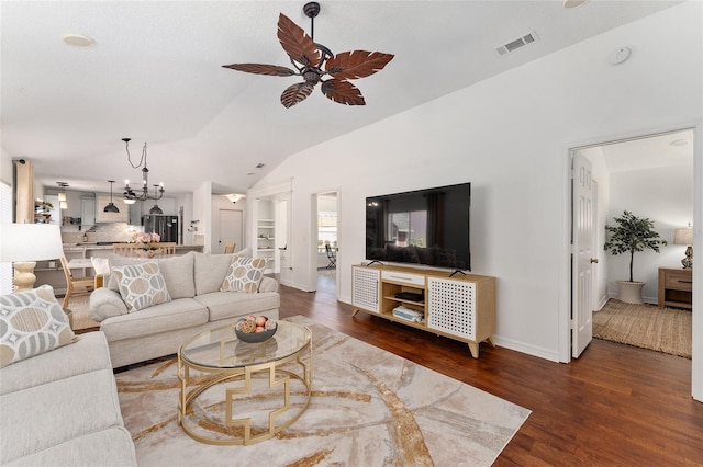 living room with vaulted ceiling, visible vents, wood finished floors, and ceiling fan with notable chandelier