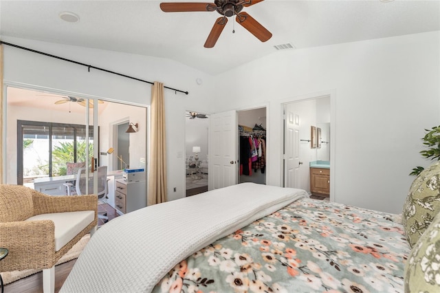 bedroom with vaulted ceiling, connected bathroom, a spacious closet, ceiling fan, and visible vents