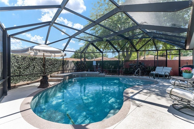 view of pool with glass enclosure, a patio area, a fenced in pool, and a fenced backyard