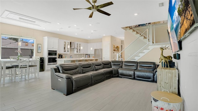 26516 Savage Cir, Howey In The Hills, FL 34737 - living room featuring ceiling fan, stairway, light wood-style floors, and recessed lighting