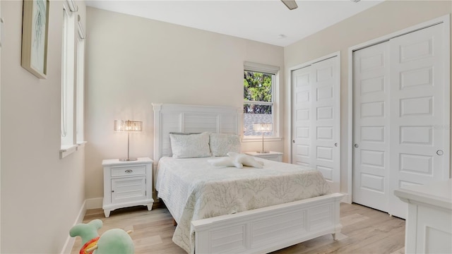 26516 Savage Cir, Howey In The Hills, FL 34737 - bedroom featuring light wood-style flooring, two closets, and baseboards