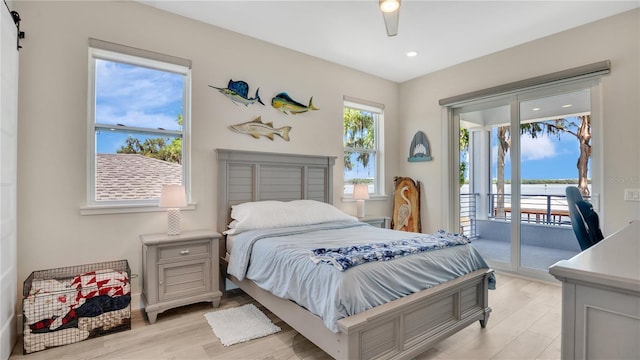26516 Savage Cir, Howey In The Hills, FL 34737 - bedroom featuring access to exterior, light wood-type flooring, recessed lighting, a ceiling fan, and a water view