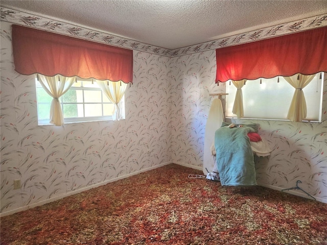 unfurnished bedroom featuring a textured ceiling and carpet floors