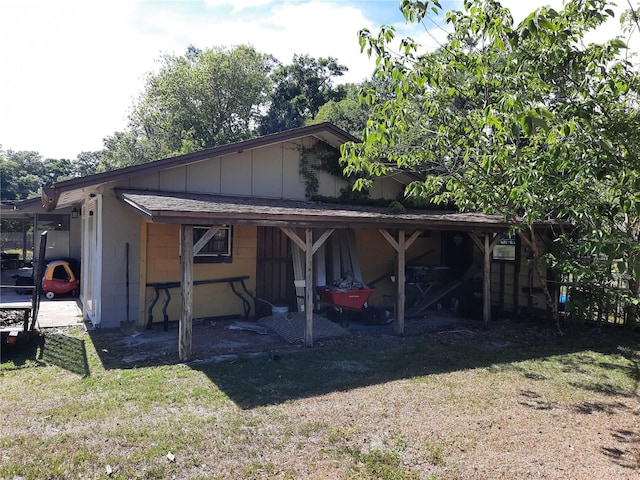 exterior space with concrete block siding and a lawn