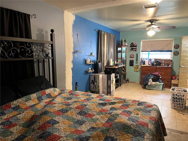 bedroom with ceiling fan, tile patterned floors, and visible vents