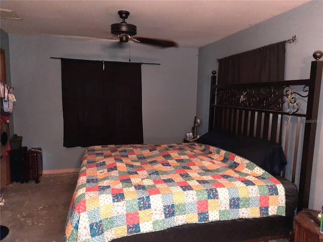 bedroom with concrete flooring, a ceiling fan, and baseboards