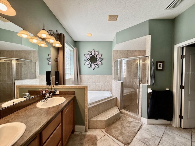 30554 Quince Ave, Eustis, FL 32736 - full bath featuring a garden tub, a stall shower, tile patterned flooring, double vanity, and a textured ceiling