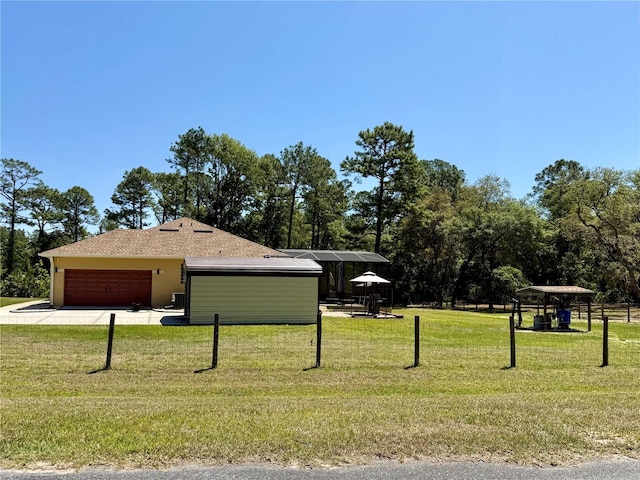 30554 Quince Ave, Eustis, FL 32736 - view of side of home with an attached garage, a yard, concrete driveway, stucco siding, and a shingled roof