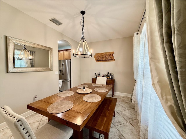 30554 Quince Ave, Eustis, FL 32736 - dining room featuring arched walkways, light tile patterned floors, and baseboards
