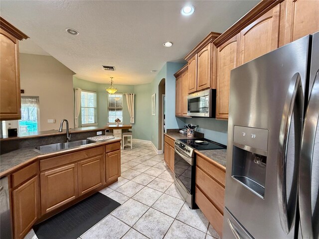30554 Quince Ave, Eustis, FL 32736 - kitchen featuring appliances with stainless steel finishes, a sink, light tile patterned floors, dark countertops, and recessed lighting
