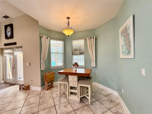 30554 Quince Ave, Eustis, FL 32736 - dining space featuring light tile patterned floors, a textured ceiling, and baseboards