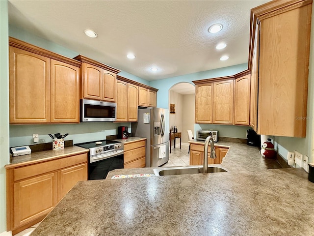 30554 Quince Ave, Eustis, FL 32736 - kitchen featuring appliances with stainless steel finishes, a sink, arched walkways, a textured ceiling, and recessed lighting
