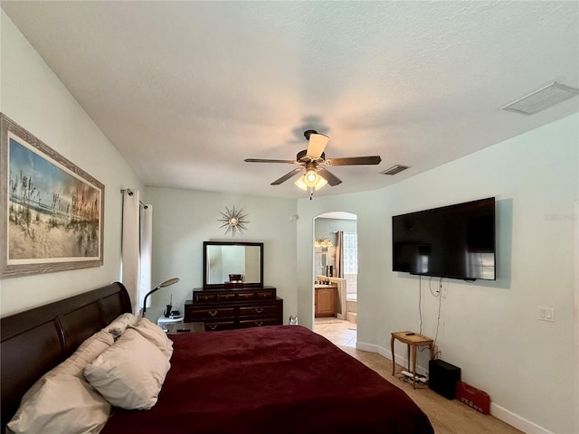 30554 Quince Ave, Eustis, FL 32736 - bedroom featuring arched walkways, light colored carpet, baseboards, ensuite bath, and a ceiling fan
