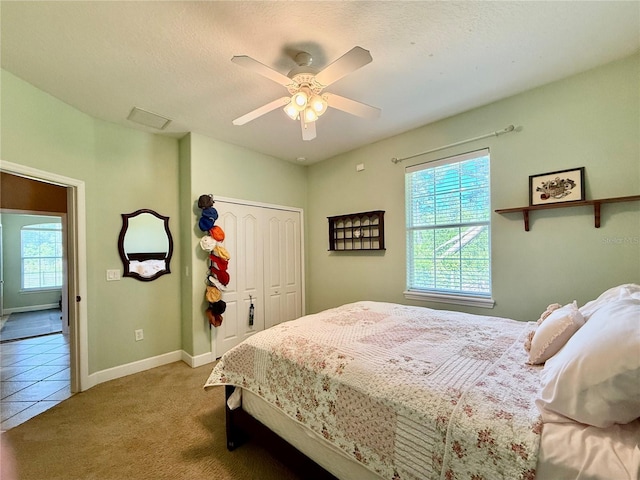 30554 Quince Ave, Eustis, FL 32736 - carpeted bedroom with a closet, a ceiling fan, baseboards, tile patterned floors, and a textured ceiling