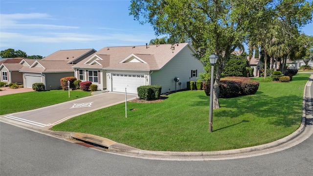 view of front of property featuring an attached garage, aphalt driveway, and a front lawn