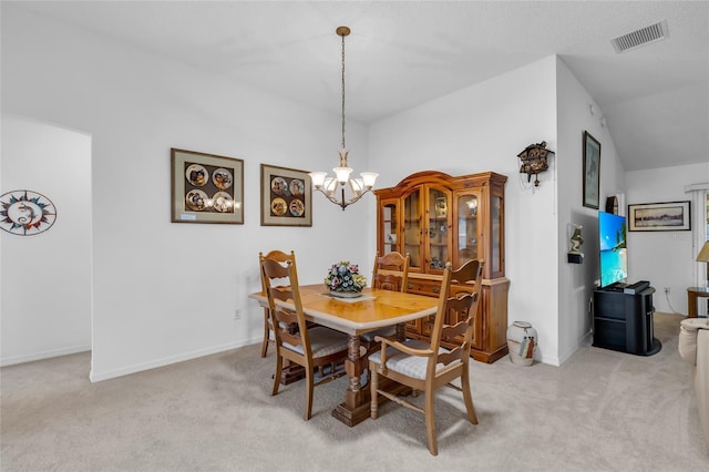 dining area with visible vents, baseboards, light carpet, and an inviting chandelier
