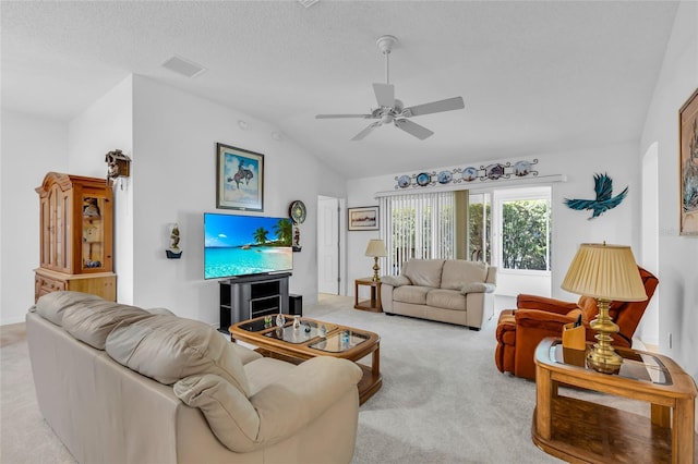 living room featuring lofted ceiling, a ceiling fan, visible vents, and light carpet