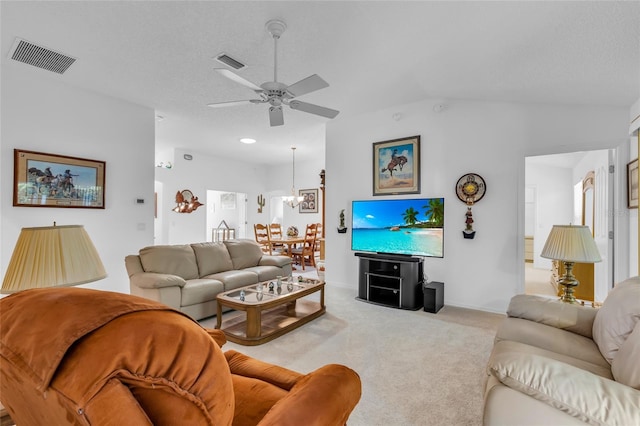 living area with vaulted ceiling, visible vents, light carpet, and ceiling fan with notable chandelier