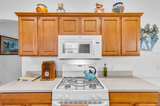 kitchen featuring white appliances and light countertops