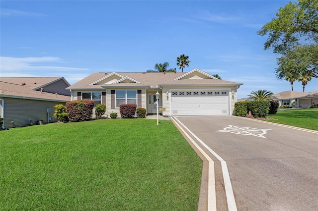 ranch-style house featuring driveway, a front yard, and a garage