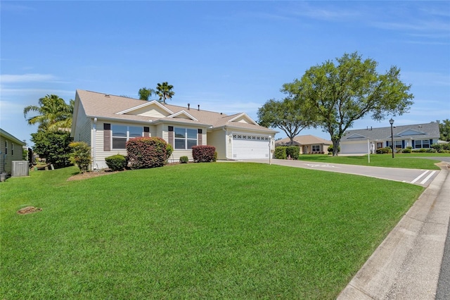view of front of home featuring a garage, a front lawn, and concrete driveway