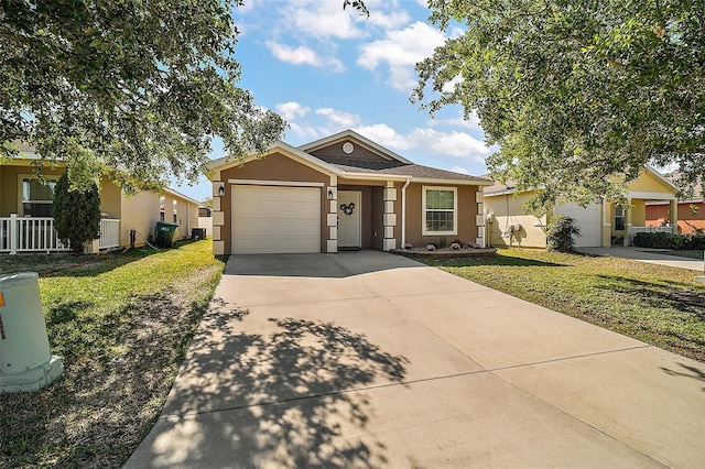 ranch-style home featuring a front yard, stucco siding, driveway, and an attached garage