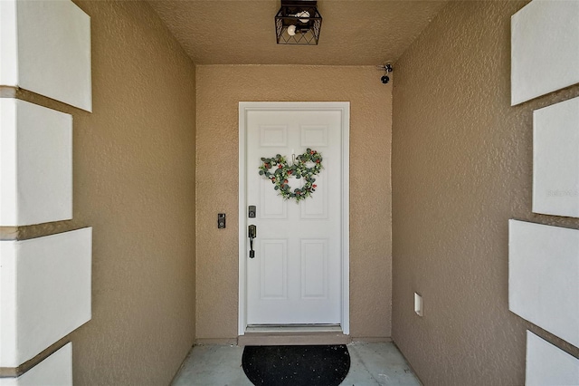 doorway to property with stucco siding