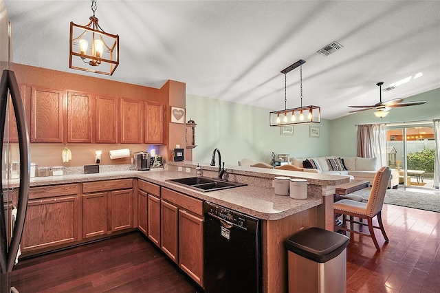 kitchen featuring a peninsula, dishwasher, a sink, visible vents, and open floor plan