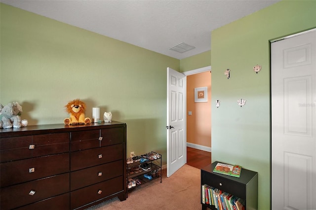 carpeted bedroom with baseboards and visible vents