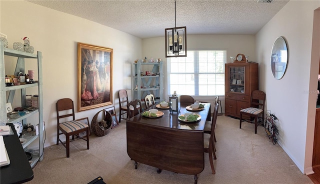 dining area featuring light carpet, visible vents, a textured ceiling, and a notable chandelier