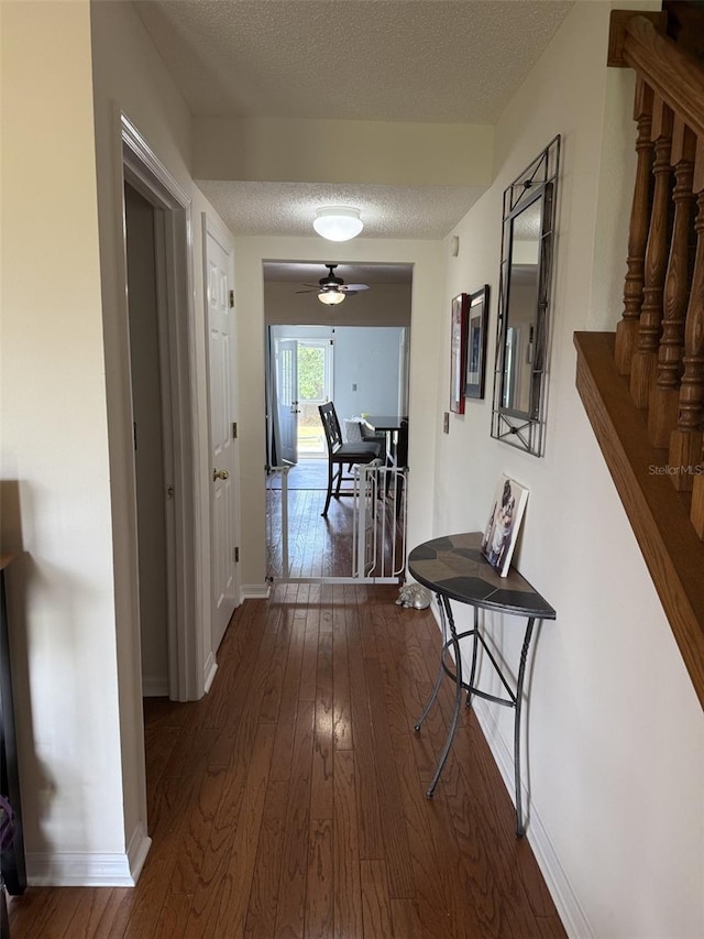 4941 Tradition Dr, Lakeland, FL 33812 - corridor with a textured ceiling, dark wood finished floors, and baseboards