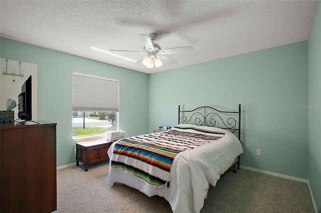 bedroom featuring baseboards, carpet flooring, a textured ceiling, and ceiling fan