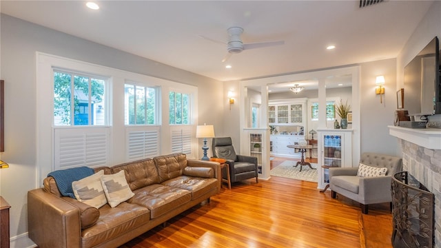 908 N Tremain St, Mount Dora, FL 32757 - living area featuring plenty of natural light, ceiling fan, a fireplace, and light wood-style flooring