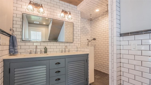 908 N Tremain St, Mount Dora, FL 32757 - bathroom featuring double vanity, walk in shower, tile walls, and a sink