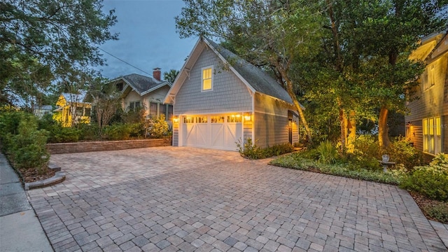 908 N Tremain St, Mount Dora, FL 32757 - exterior space with a garage, driveway, and a chimney