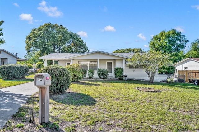 single story home featuring fence and a front yard