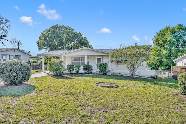 single story home with a front lawn, fence, and a carport