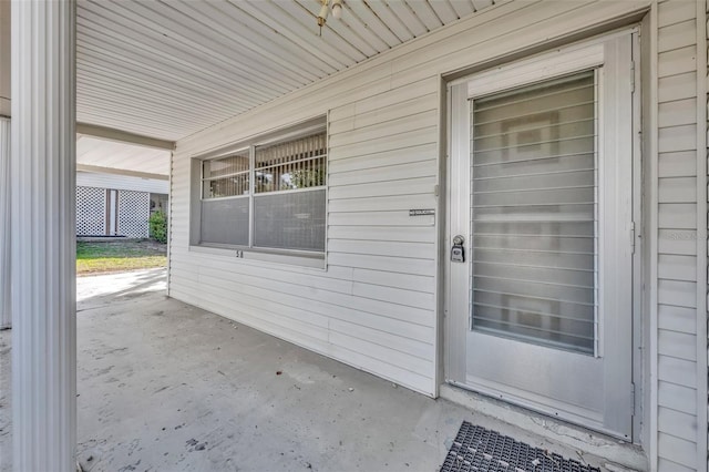 view of exterior entry featuring covered porch
