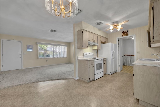 kitchen featuring visible vents, under cabinet range hood, white appliances, and a sink