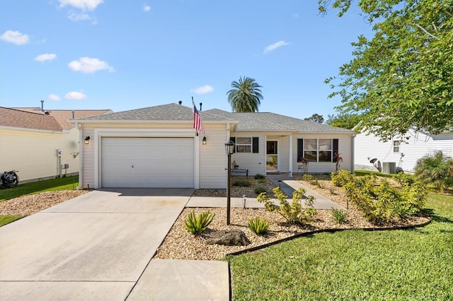 ranch-style house featuring an attached garage, driveway, and cooling unit