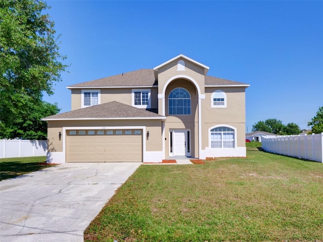 traditional-style home featuring an attached garage, a front yard, stucco siding, and fence