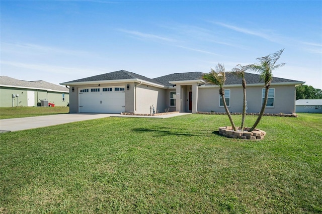 view of front of home featuring an attached garage, driveway, a front yard, and stucco siding