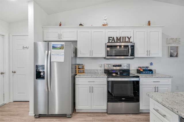 kitchen featuring white cabinets, stainless steel appliances, light wood-style floors, and light stone counters