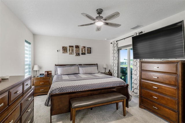 bedroom featuring visible vents, light colored carpet, and multiple windows