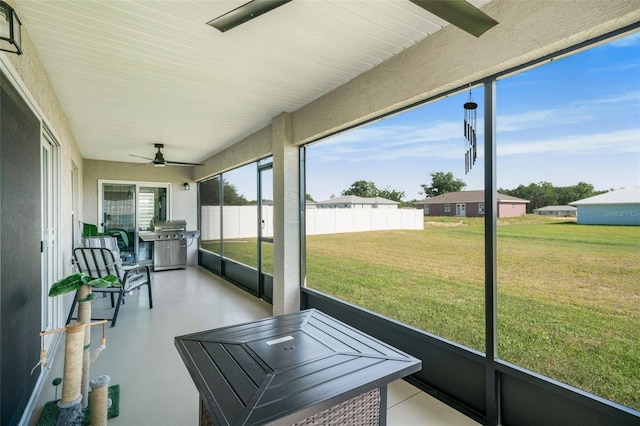 sunroom / solarium featuring ceiling fan