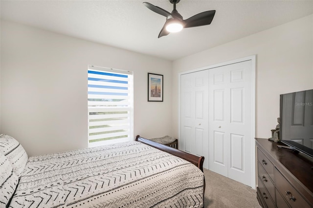 carpeted bedroom featuring a closet and ceiling fan