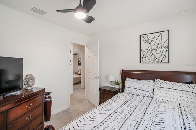 bedroom with baseboards, visible vents, light colored carpet, and ceiling fan