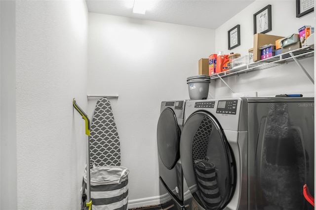 clothes washing area featuring separate washer and dryer and laundry area