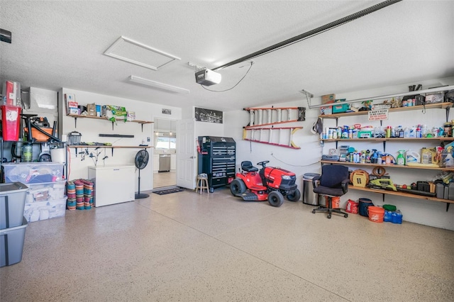 garage featuring separate washer and dryer, a garage door opener, and fridge